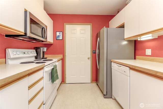 kitchen with white cabinets, white appliances, and light countertops