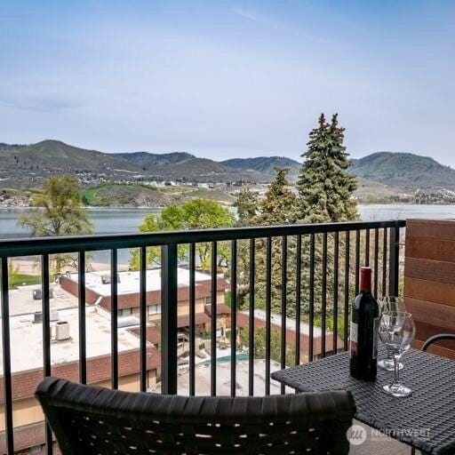 balcony with a water and mountain view