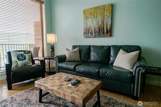 living area with plenty of natural light and baseboards