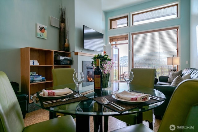 dining room featuring a glass covered fireplace