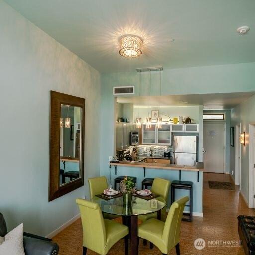 dining room with baseboards and visible vents