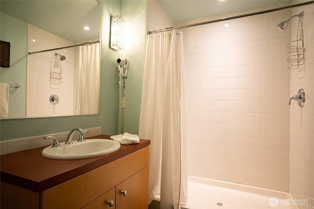 bathroom featuring a stall shower and vanity