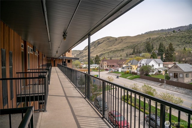 balcony featuring a residential view and a mountain view