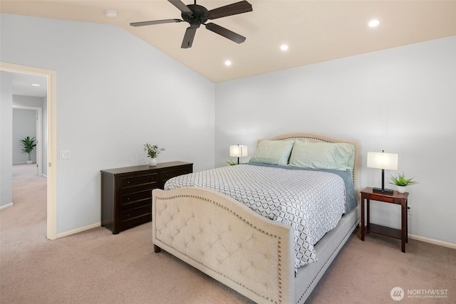 bedroom featuring light carpet, baseboards, and lofted ceiling