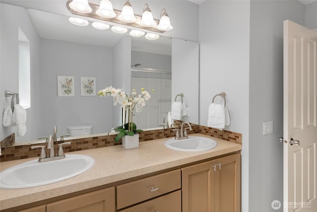 full bathroom with a shower stall, toilet, backsplash, and a sink