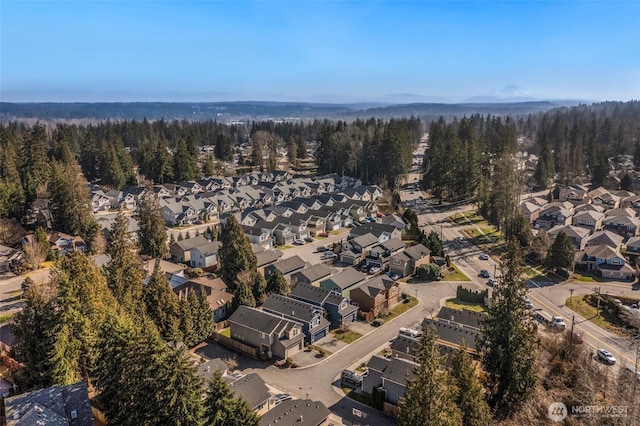 aerial view featuring a forest view and a residential view