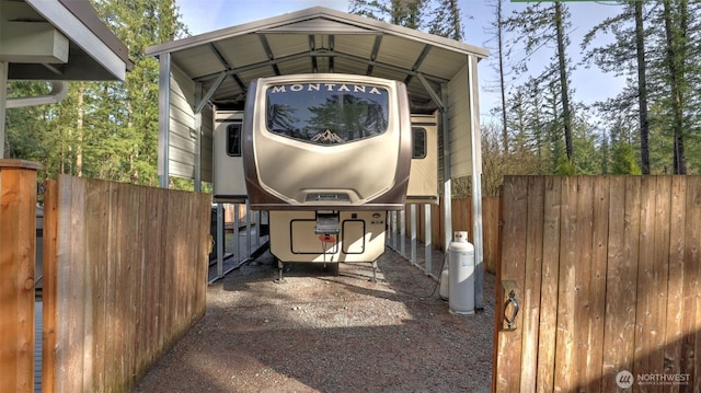 view of car parking with a carport and fence