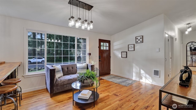 entryway featuring visible vents, plenty of natural light, and light wood-style floors