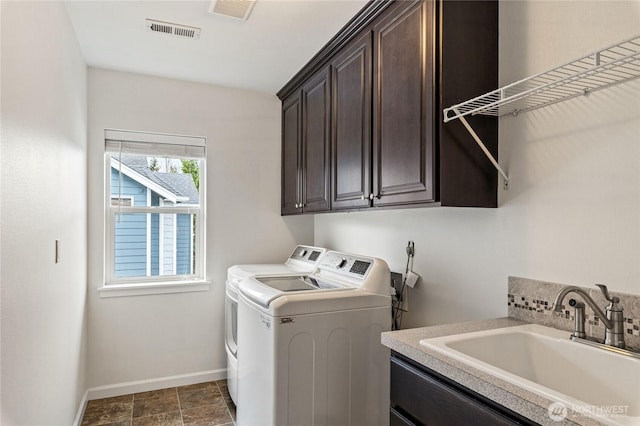 laundry room featuring a sink, visible vents, cabinet space, and independent washer and dryer