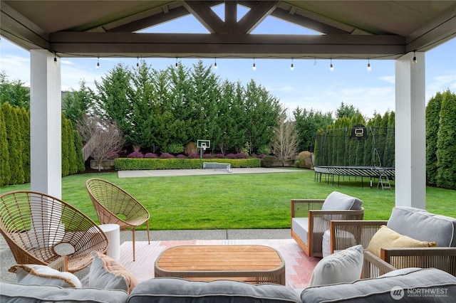 view of patio with an outdoor living space and a trampoline