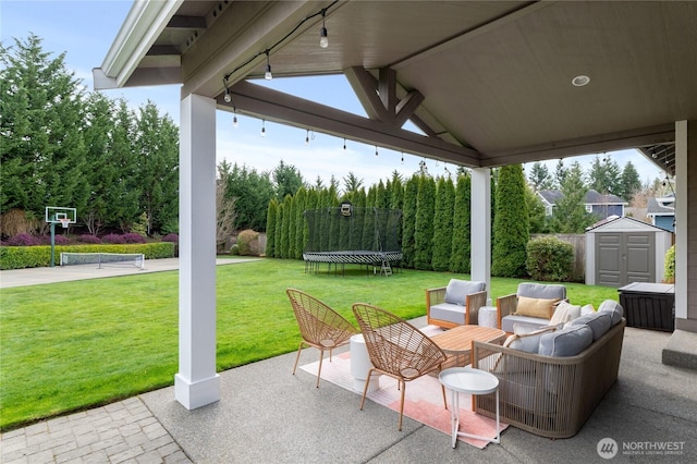 view of patio / terrace with an outdoor living space, a gazebo, an outdoor structure, a storage shed, and a trampoline