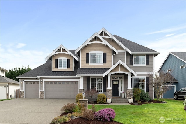 craftsman-style home featuring stone siding, concrete driveway, a front yard, and roof with shingles