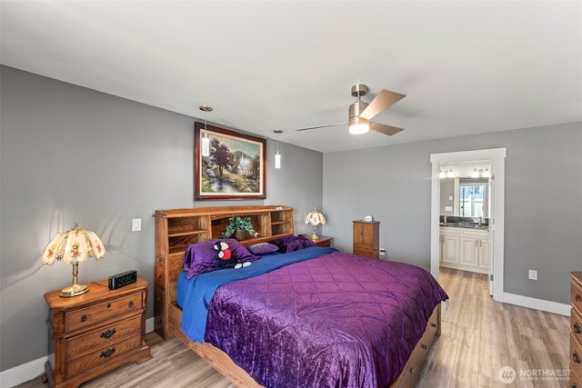 bedroom featuring ceiling fan, light wood finished floors, connected bathroom, and baseboards