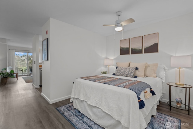 bedroom with a ceiling fan, access to exterior, wood finished floors, and baseboards