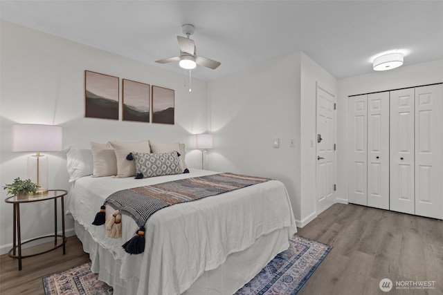 bedroom featuring a closet, a ceiling fan, baseboards, and wood finished floors