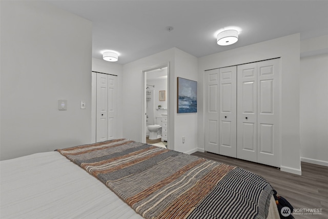 bedroom featuring wood finished floors, baseboards, and ensuite bathroom