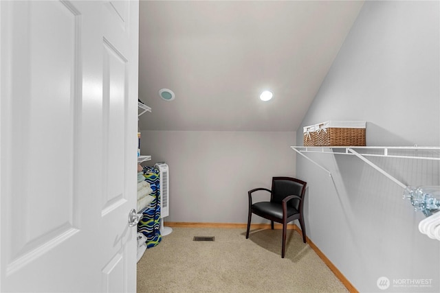 spacious closet featuring visible vents, carpet, and lofted ceiling