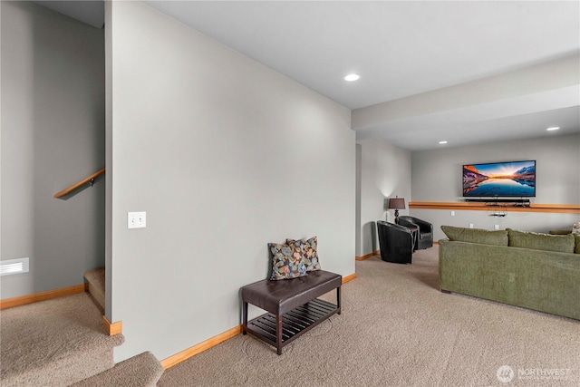 carpeted living area featuring recessed lighting, baseboards, and stairs