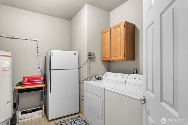 washroom featuring water heater, cabinet space, and washer and clothes dryer