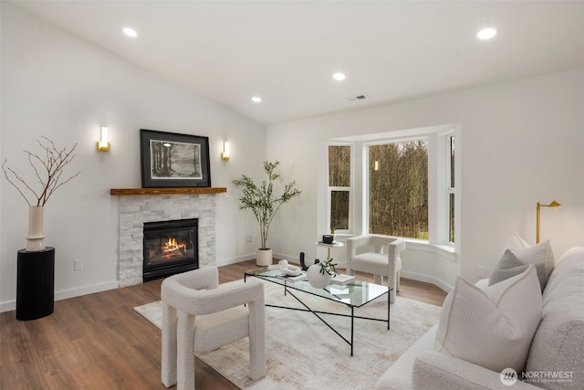 living room featuring recessed lighting, visible vents, wood finished floors, and vaulted ceiling