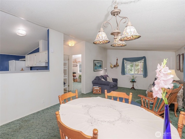 carpeted dining space with vaulted ceiling