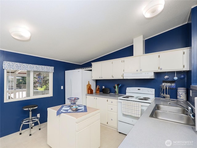 kitchen with white appliances, light countertops, a sink, and under cabinet range hood