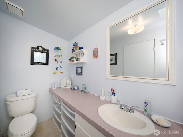 bathroom featuring tile patterned flooring, visible vents, vanity, and toilet