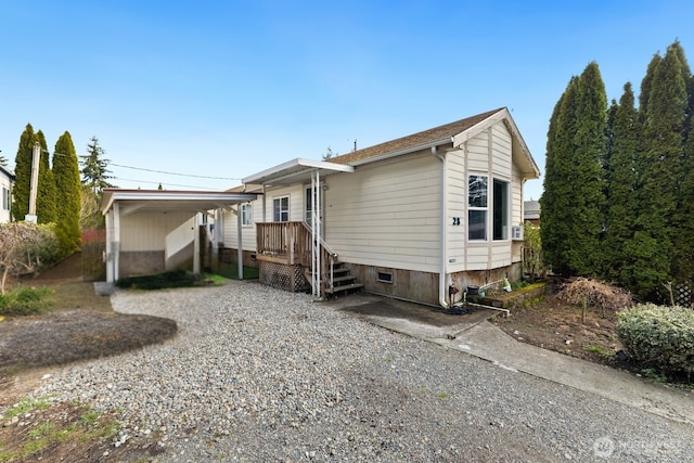 view of front of property with a carport and gravel driveway