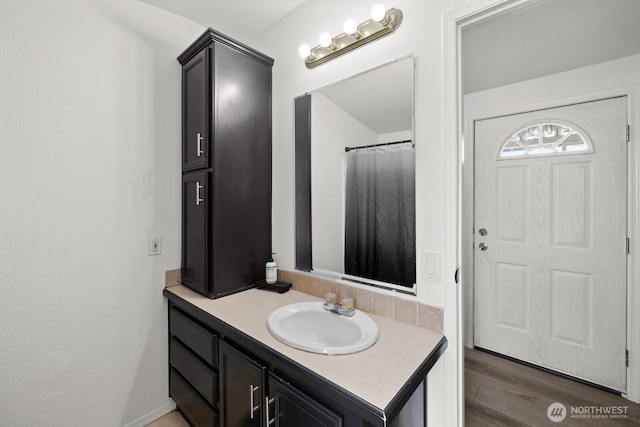 full bath featuring wood finished floors and vanity