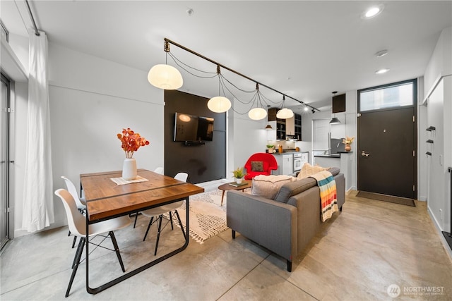 living area with recessed lighting and finished concrete flooring