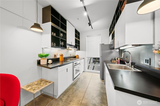 kitchen with open shelves, oven, a sink, dark countertops, and stainless steel microwave