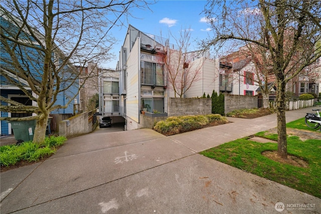 view of front of property with a residential view and fence