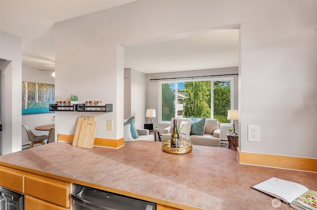 kitchen featuring a baseboard radiator, open floor plan, ceiling fan, and stainless steel dishwasher