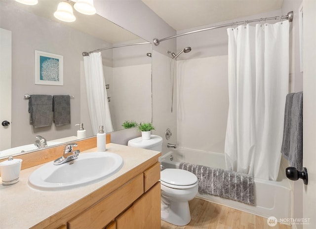 bathroom with vanity, wood finished floors, shower / bath combo with shower curtain, and toilet