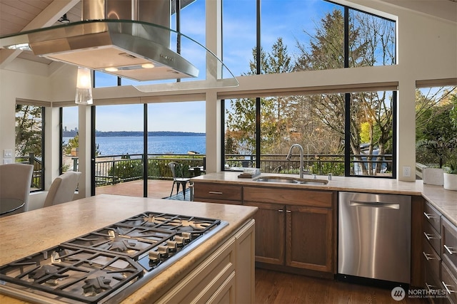 kitchen with a sink, extractor fan, a water view, appliances with stainless steel finishes, and dark wood-style flooring