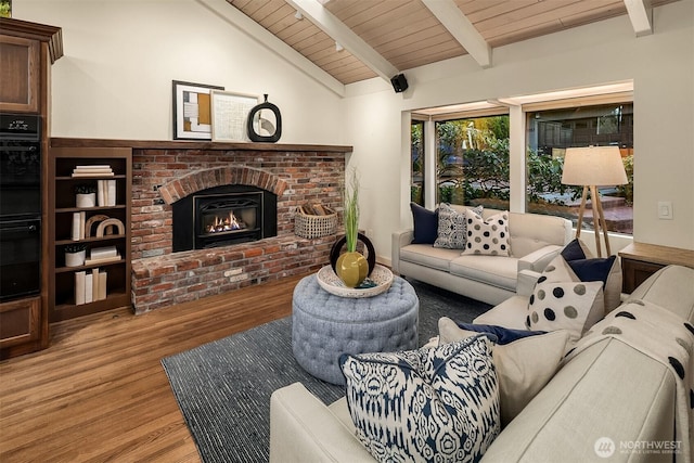 living room featuring wood ceiling, a fireplace, vaulted ceiling with beams, and wood finished floors