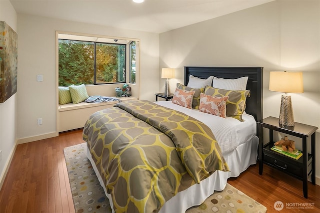 bedroom featuring baseboards and wood finished floors