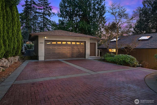 garage with decorative driveway