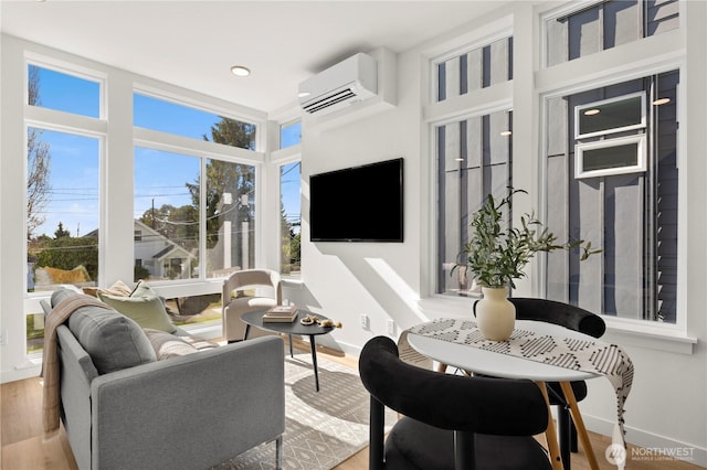 sunroom featuring an AC wall unit