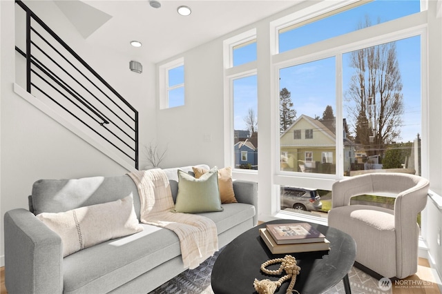 living area featuring stairs and recessed lighting