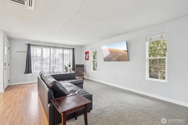 living room with visible vents and baseboards