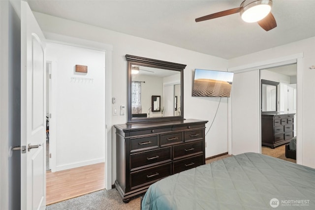 carpeted bedroom featuring baseboards and ceiling fan