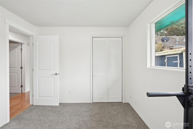 unfurnished bedroom featuring a closet and carpet floors