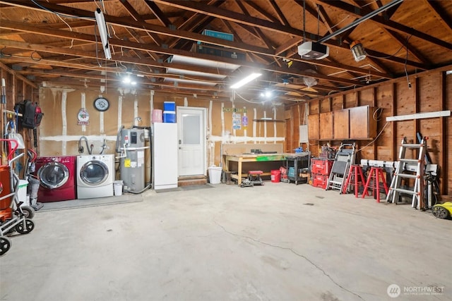 garage with independent washer and dryer, a garage door opener, and hybrid water heater