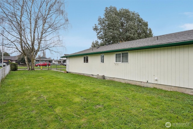 exterior space with a lawn and fence