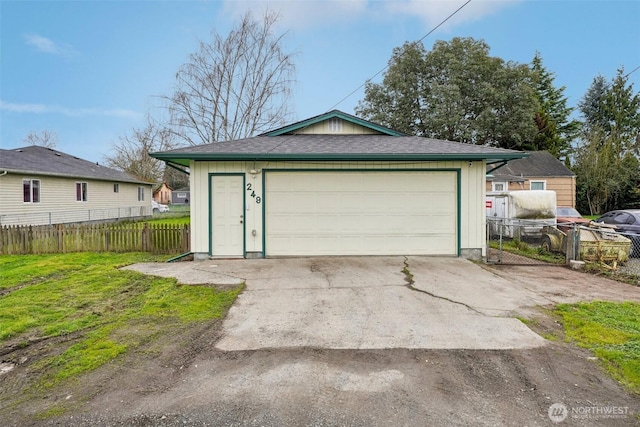 detached garage featuring fence