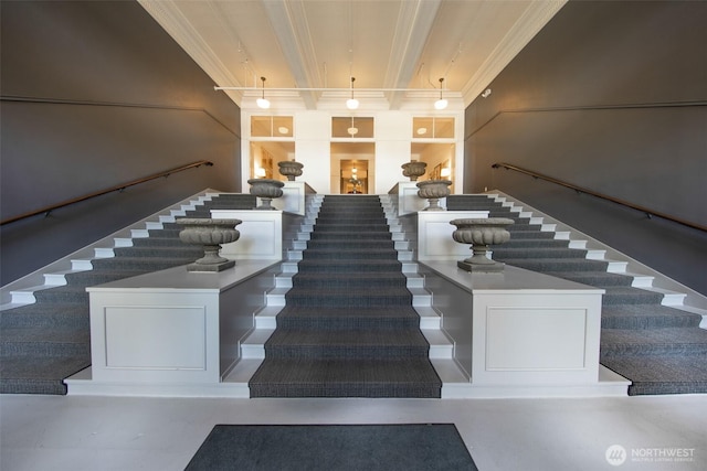 staircase featuring crown molding and beamed ceiling