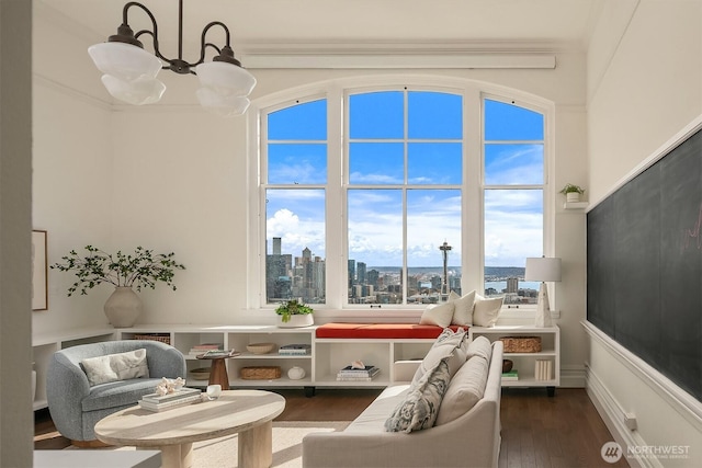 living room with a notable chandelier, a city view, and wood finished floors