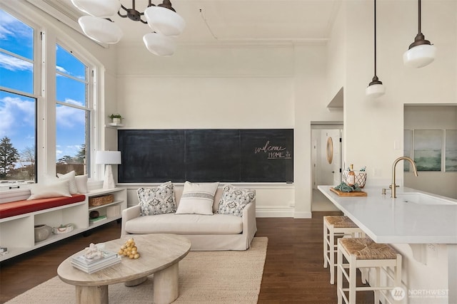 living area with baseboards and dark wood-style flooring