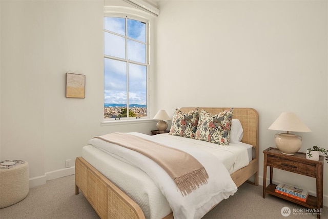 bedroom with multiple windows, baseboards, and carpet floors